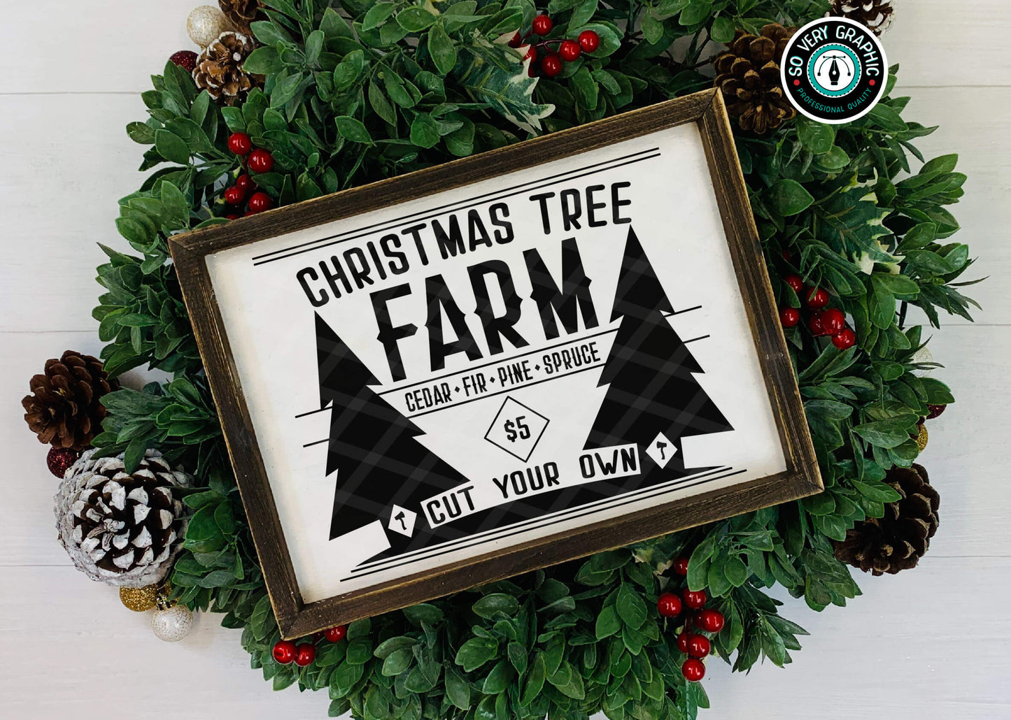 Christmas Tree Farm SVG Cut File displayed in a rustic wood frame on top of winter greenery, holly and pinecones