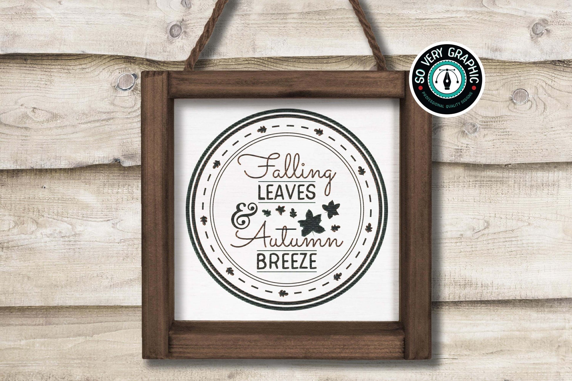 Falling Leaves & Autumn Breeze SVG Cut File from So Very Graphic in a rustic wood frame hanging from a farmhouse shiplap wall