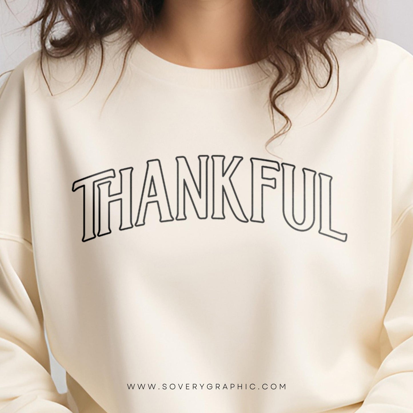 Beige sweatshirt with 'THANKFUL' text on a plain background