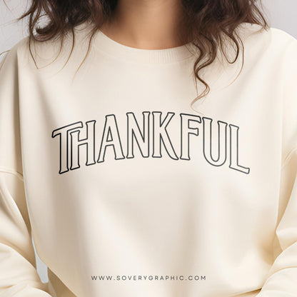 Beige sweatshirt with 'THANKFUL' text on a plain background